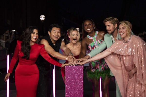 America Ferrera, from left, Simu Liu, Margot Robbie, Issa Rae, Ryan Gosling and Greta Gerwig pose for photographers at the photo call for the film 'Barbie' on Wednesday, July 12, 2023, in London. (Vianney Le Caer/Invision/AP)