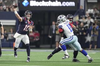 Houston Texans quarterback Davis Mills (10) throws a pass under pressure from Dallas Cowboys linebacker Micah Parsons (11) during the first half of an NFL football game, Sunday, Dec. 11, 2022, in Arlington, Texas. (AP Photo/Tony Gutierrez)