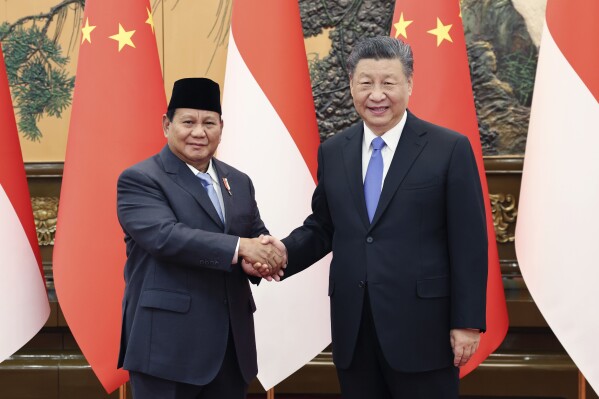 In this photo released by Xinhua News Agency, Chinese President Xi Jinping at right shakes hands with Indonesian President-elect Prabowo Subianto at the Great Hall of the People in Beijing on Monday, April 1, 2024. (Yao Dawei/Xinhua via AP)