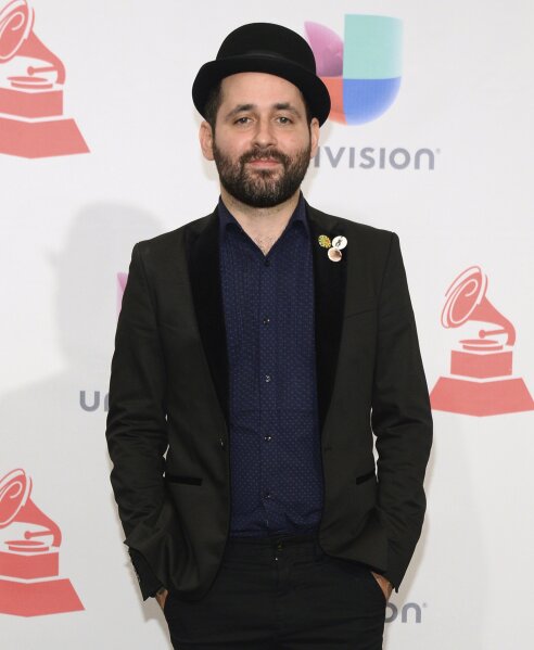 FILE - In this Nov. 19, 2015, file photo, Eduardo Cabra, of Calle 13, poses in the press room at the 16th annual Latin Grammy Awards in Las Vegas. Cabra killed off his "Visitante" persona in the graphic new video "La Cabra Jala Pal Monte," stepping into the forefront for the first time as CABRA with his newly formed record label, La Casa del Sombrero. (Photo by Al Powers/Invision/AP, File)