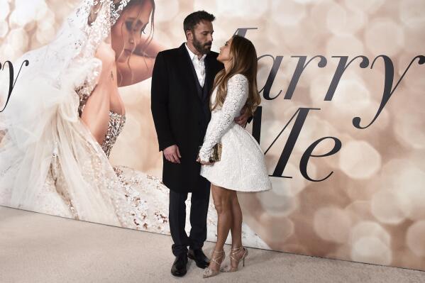 FILE - Cast member Jennifer Lopez, right, and Ben Affleck attend a photo call for a special screening of "Marry Me" at DGA Theater on Feb. 8, 2022, in Los Angeles. Lopez and Affleck said “I do” again this weekend. But instead of in a late night Las Vegas drive through chapel, this time it was in front of friends and family in Georgia, a person close to the couple who was not authorized to speak publicly said Sunday, Aug. 21, 2022. (Photo by Jordan Strauss/Invision/AP, File)