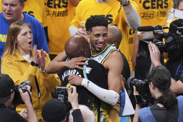 Indiana Pacers guard Tyrese Haliburton (0) hugs his father John Haliburton following Game 5 of an NBA basketball first-round playoff series against the Milwaukee Bucks, Tuesday, April 29, 2025, in Indianapolis. (AP Photo/Michael Conroy)