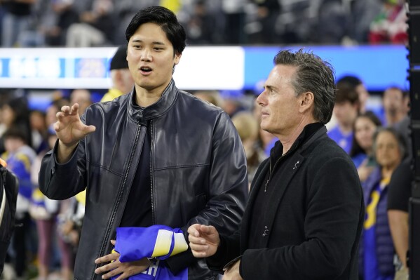 Los Angeles Dodgers' Shohei Ohtani and his agent Nez Balelo attend an NFL football game between the Los Angeles Rams and the New Orleans Saints, Thursday, Dec. 21, 2023, in Inglewood, Calif. (AP Photo/Ryan Sun, File)