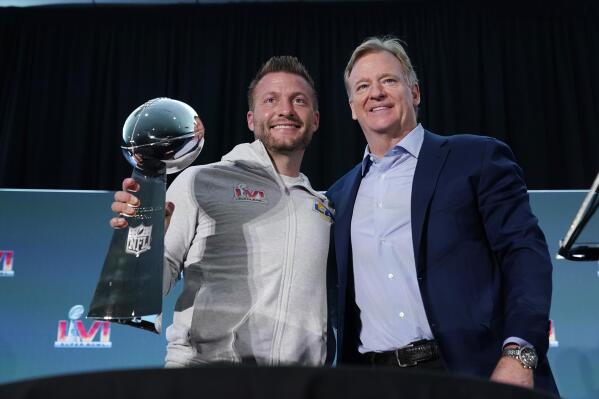 CORRECTS SPELLING TO LOMBARDI, NOT LOMBARDY AS ORIGINALLY SENT - Los Angeles Rams head coach Sean McVay, left, holds the Vince Lombardi trophy during a press conference while posing for photos with league commissioner Roger Goodell following the NFL football team's Super Bowl win over the Cincinnati Bengals Monday, Feb. 14, 2022, in Los Angeles. (AP Photo/Marcio Jose Sanchez)