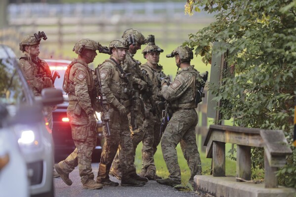 Pennsylvania State police search the woods and a creek in Pennsbury Township, Pa., on Tuesday, Sept. 5, 2023. Murderer Danilo Cavalcante was able to escape a prison yard in suburban Pennsylvania last week by climbing up a wall and over razor wire, officials said at a news conference Wednesday. (Steven M. Falk/The Philadelphia Inquirer via AP)