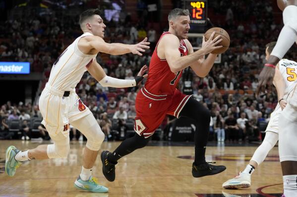 Chicago Bulls guard Goran Dragic, right, drives to the basket as Miami Heat guard Tyler Herro defends during the first half of an NBA basketball game, Tuesday, Dec. 20, 2022, in Miami. (AP Photo/Lynne Sladky)