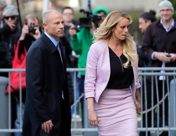 FILE - In this April 16, 2018 file photo, Stormy Daniels, right, and her attorney Michael Avenatti turn from the microphones after speaking as they leave federal court in New York. California lawyer Michael Avenatti wants leniency at sentencing for defrauding former client Stormy Daniels of hundreds of thousands of dollars, his lawyers say, citing a letter in which he told Daniels: “I am truly sorry.” The emailed letter, dated May 13, was included in a submission his lawyers made late Thursday, May 19, 022, in Manhattan federal court in advance of a June 2 sentencing. (AP Photo/Seth Wenig, File)