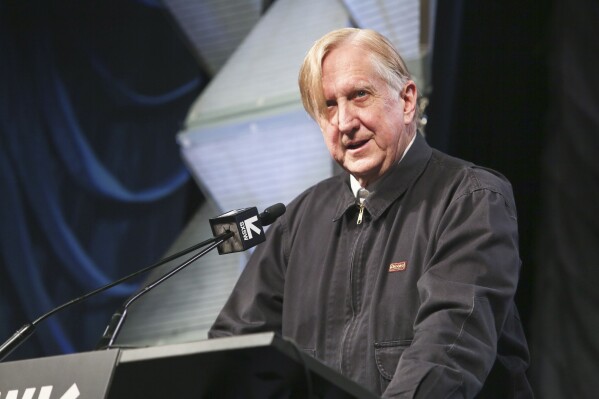 FILE - T Bone Burnett gives a keynote during the South by Southwest Music Festival at the Austin Convention Center on Wednesday, March 13, 2019, in Austin, Texas. Burnett, most celebrated for his production acumen, uprooted from Los Angeles to move to Nashville and recorded a warm-hearted disc of his own songs for the first time in nearly two decades. Indie rockers Lucius and Rosanne Cash add their voices to the acoustic collection. (Photo by Jack Plunkett/Invision/AP, File)