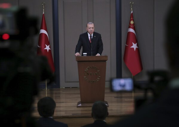 
              Turkey's President Recep Tayyip Erdogan talks to members of the media at the airport in Ankara, Turkey before departing to France, Saturday, Nov. 10, 2018. Erdogan said at the news conference that officials from Saudi Arabia, the United States, Germany, France and Britain have listened to audio recordings related to the killing of journalist Jamal Khashoggi at the Saudi Consulate in Istanbul. Erdogan's comments were the first public confirmation of the existence of recordings of the Oct. 2 killing of The Washington Post columnist at the consulate. (Presidential Press Service via AP, Pool)
            