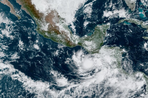 This satellite image provided by NOAA on Monday, Oct. 30, 2023, shows Tropical Storm Pilar approaching El Salvador on the Pacific coast of Central America. (NOAA via AP)