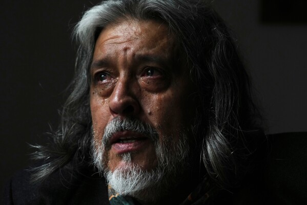 Eduardo Castano sheds tears while thinking about his wife Marité, who died in 2024, unable to secure drugs that had been covered by the federal agency DADSE, which President Javier Milei dissolved, in Buenos Aires, Argentina, Wednesday, April 16, 2025. (AP Photo/Natacha Pisarenko)