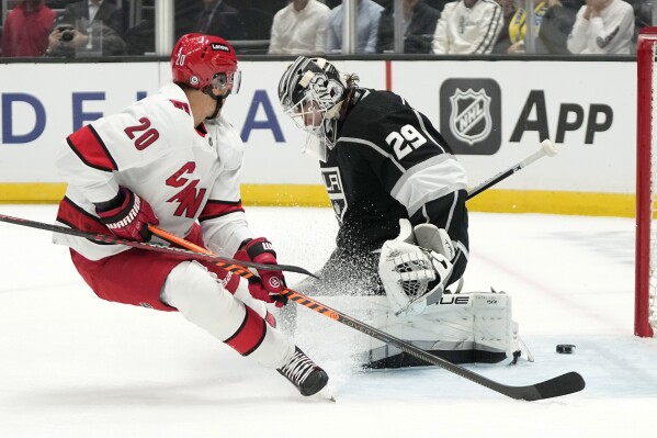 Carolina Hurricanes center Sebastian Aho, left, scores on Los Angeles Kings goaltender Pheonix Copley during the first period of an NHL hockey game Saturday, Oct. 14, 2023, in Los Angeles. (AP Photo/Mark J. Terrill)