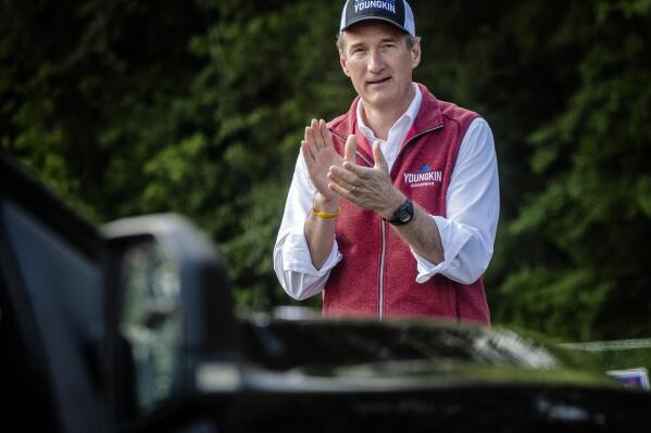 Gubernatorial candidate Glenn Youngkin works the line of cars as the Virginia GOP holds a drive-thru primary to select candidates for the 2021 general election, Saturday, May 8, 2021, in Annandale, Va. (Bill O'Leary/The Washington Post via AP)