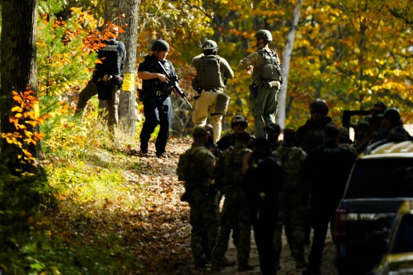 Law enforcement continue a manhunt in the aftermath of a mass shooting, in Durham, Maine, Friday, Oct. 27, 2023..Authorities are scouring hundreds of acres of family-owned property, sending dive teams to the bottom of a river and scrutinizing a possible suicide note in the second day of their intensive search for an Army reservist accused of fatally shooting several people in Maine.(AP Photo/Matt Rourke)