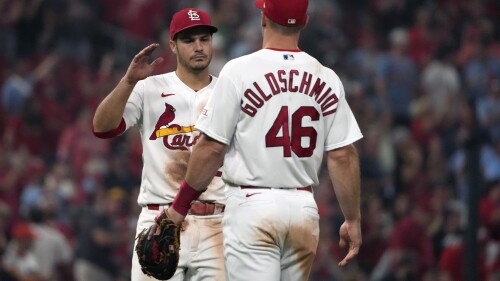 St. Louis Cardinals' Nolan Arenado and Paul Goldschmidt (46) celebrate a 4-2 victory over the Houston Astros following a baseball game Tuesday, June 27, 2023, in St. Louis. (AP Photo/Jeff Roberson)