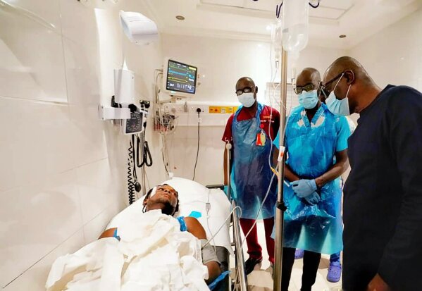 In this photo released by the Lagos State government press, governor Babajide Sanwo-Olu, right, visit victims injured in last night's protests in a hospital in Lagos, Nigeria, Wednesday Oct. 21, 2020. Nigerians protesting against police brutality stayed on the streets in Lagos on Wednesday, breaking the government curfew following a night of chaotic violence in which demonstrators were fired upon, sparking global outrage. (Lagos State government press Via AP)