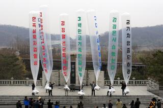 FILE - In this April 15, 2011, file photo, Park Sang-hak, center, a refugee from the North who now runs the group Fighters for a Free North Korea from a small Seoul office, and South Korean conservative activists prepare to release balloons bearing leaflets condemning North Korean leader during an anti-North Korea rally against "The Day of the Sun," the anniversary of Kim Il Sung's birth 99 years, at the Imjingak Pavilion near the border village of Panmunjom in Paju, South Korea. Park said Friday, April 30, 2021, he launched 500,000 propaganda leaflets by balloon into North Korea this week in defiance of a contentious new law that criminalizes such actions. The balloons read "Overthrow Kim Jong Il's dictatorship." (AP Photo/Lee Jin-man, file)