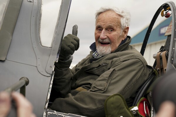102-year-old Jack Hemmings AFC gestures after flying a Spitfire plane to mark 80th anniversary of the military charity Mission Aviation Fellowship (MAF) at Heritage Hanger at London Biggin Hill, England, Monday, Feb. 5, 2024. Hemmings took to the skies in Britain's best-loved Second World War aircraft to raise money for MAF, the charity he co-founded almost 80 years ago. (Gareth Fuller/PA via AP)