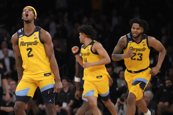 Marquette guard Chase Ross (2) reacts after scoring a 3-point basket against Villanova in overtime of an NCAA college basketball game in the quarterfinals of the Big East Conference tournament, Friday, March 15, 2024, in New York. (AP Photo/Mary Altaffer)