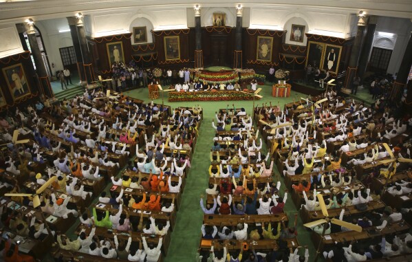 FILE- Newly elected lawmakers from India's ruling alliance led by the Hindu nationalist Bharatiya Janata Party raise their hands in support of Narendra Modi being elected their leader in New Delhi, India, May 25, 2019. India's 6-week-long general elections begin on April 19, 2024, and results will be announced on June 4. The voters, who comprise over 10% of the world's population, will elect 543 members for the lower house of Parliament for a term of five years. (AP Photo/Manish Swarup, File)