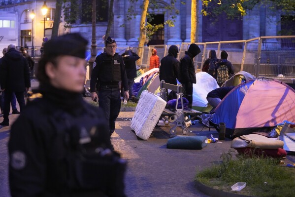 Miigrants are being evicted from a makeshift camp, Tuesday, April 30, 2024 in Paris. Similar operations are carried out by the police authorities on a daily basis in the months leading to the Olympics. (AP Photo/Michel Euler)