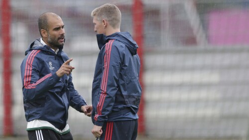 FILE - Bayern head coach Pep Guardiola of Spain, left talks to Bastian Schweinsteiger during a training session prior to the Champions League group D soccer match between FC Bayern Munich and CSKA Moscow, in Munich, Germany, Monday, Sept. 16, 2013. Former Germany winger Bastian Schweinsteiger says Pep Guardiola shares blame for the national team’s decline. He tells British radio station Talksport that Germany lost its values because of the Spanish coach. (AP Photo/Matthias Schrader, File)