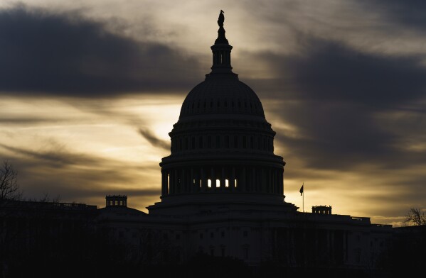FILE - The Capitol is seen in Washington, early Friday, Dec. 17, 2021. Since the Salem Witch Trials, tales of dark plots and secret organizations have emerged again and again in America, influencing public opinion and even the outcome of elections. (AP Photo/J. Scott Applewhite, File)