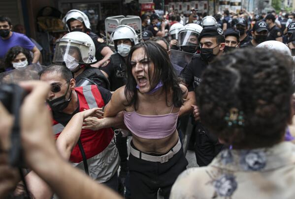 Protesters are detained by police in central Istanbul, Saturday, June 26, 2021. Police used tear gas to disperse the crowds and detained dozens of LGTBI activists as hundreds defied a ban and tried to stage a gay pride event. (AP Photo/Emrah Gurel)