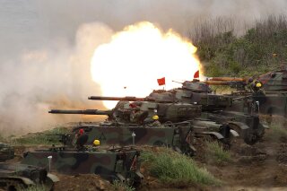 
              FILE- In this Tuesday, May 25, 2017, file photo, a line of U.S. M60A3 Patton tank fire at targets during the annual Han Kuang exercises on the outlying Penghu Island, Taiwan. Beijing has strongly protested a U.S. plan to sell $1.4 billion worth of arms to Taiwan and demanded that the deal be canceled. Chinese foreign ministry spokesman Lu Kang on Friday said Washington should immediately stop the sale to avoid harming relations with Beijing. (AP Photo/Chiang Ying-ying, File)
            