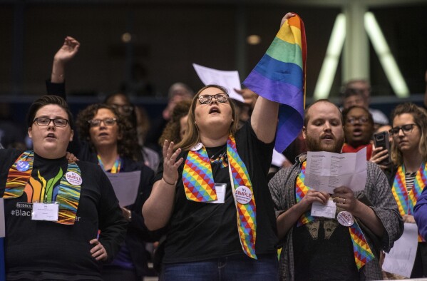 FILE - Shelby Ruch-Teegarden, center, of Garrett-Evangelical Theological Seminary, joins other protestors during the United Methodist Church's special session of the general conference in St. Louis, Tuesday, Feb. 26, 2019. United Methodist rules forbid same-sex marriage rites and the ordination of “self-avowed practicing homosexuals,” but progressive Methodist churches in the U.S. have increasingly been defying these rules. (AP Photo/Sid Hastings, File)