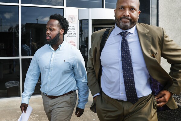 Former Memphis Police officer Desmond Mills Jr., left, along with his attorney John Keith Perry leave the Odell Horton Federal Courthouse on Wednesday, Sept. 13, 2023, in Memphis, Tenn. Mills and four other former Memphis police officers were charged with federal civil rights violations in the beating death of Tyre Nichols. (Mark Weber/The Daily Memphian)