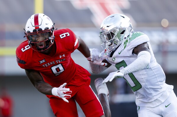 Texas Tech wide receiver Jerand Bradley (9) draws a pass interference call from Oregon defensive back Tysheem Johnson (0) during the first half of an NCAA college football game, Saturday, Sept. 9, 2023, in Lubbock, Texas. (AP Photo/Chase Seabolt)