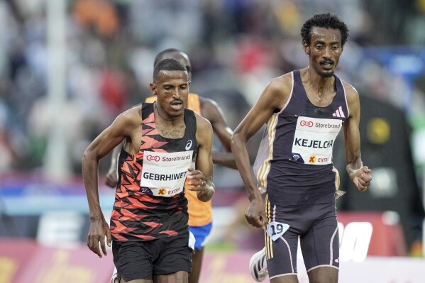 Ethiopia's Hagos Gebrhiwet, left, competes in the men's 500 meters at the Diamond League Bislett Games 2024 at Bislett Stadion, Oslo, Thursday May 30, 2024. (Heiko Junge/NTB via AP)