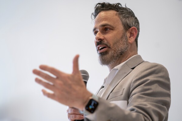 Gabe Klein, executive director of the Joint Office of Energy and Transportation at the U.S. Department of Energy, speaks throughout a Forth Design and Fund Equitable Electric Transportation For Communities workshop in Washington, Thursday, March 14, 2024. Persuading customers to go electrical, even if they do not have their own home outlet to plug into, is the objective of the Joint Office of Energy and Transportation. (AP Photo/Nathan Howard)