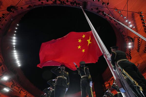The Chinese flag is raised during the opening ceremony of the 2022 Winter Olympics, Friday, Feb. 4, 2022, in Beijing. (AP Photo/Natacha Pisarenko)