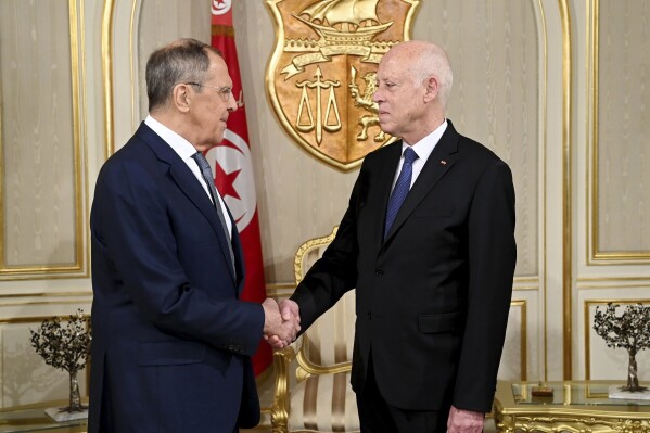 This photo provided by the Tunisia presidency shows Tunisian President Kais Saied, right, shaking hands with Russian Foreign Minister Sergey Lavrov, Thursday Dec. 21, 2023 in Tunis. Russia is working to deepen political and economic ties and spread its narrative about wars in Ukraine and Gaza. (Slim Abid/Tunisian Presidency via AP)