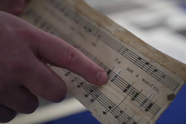 Christopher Lynch, music historian with the Center for American Music at the University of Pittsburgh, holds a piece of sheet music written by Charles Henry Pace, on Tuesday, Feb. 28, 2023, at the University of Pittsburgh, in Pittsburgh. Lynch and the university are coordinating a project to recognize the pivotal role Pace played in gospel music as an early pioneer of the genre. (AP Photo/Jessie Wardarski)