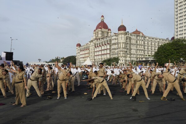 Security personal perform yoga on International Yoga Day in Mumbai, India, Saturday, June 21, 2025. (AP Photo/Rajanish Kakade)