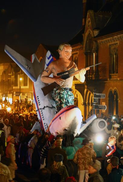 An effigy portraying Russian President Vladimir Putin is paraded through the town of Lewes, England, where an annual bonfire night procession is held by the Lewes Bonfire Societies, Wednesday Nov. 5, 2014. (AP Photo / Gareth Fuller, PA) UNITED KINGDOM OUT - NO SALES - NO ARCHIVES