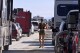 FILE - A woman walks between cars exiting the Burning Man festival in Black Rock Desert, Nev., Tuesday, Sept. 5, 2023. Festival organizers narrowly passed their environmental inspection after mass torrential rains closed roads, jammed traffic and forced many to walk miles barefoot through muck, leaving trails of debris in the remote Nevada desert, according to a Wednesday, Nov. 29, 2023, report from the U.S. Bureau of Land Management. (AP Photo/Andy Barron, File)