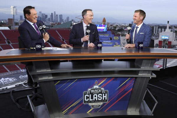 In this photo provided by Fox Sports, host Chris Myers, left, and analysts Kevin Harvick, center, and Clint Bowyer talk about the 2024 NASCAR Clash Saturday, Feb. 3, 2024, at the Coliseum in Los Angeles. Harvick's new job ramps up with Wednesday qualifying for the Daytona 500 and he closes the week by calling Sunday's “Great American Race.” It will be the first time since 2002 that Harvick, the 2007 race winner, will not be part of the Daytona 500 field. (Frank Micelotta/Fox Sports via AP)