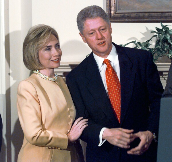 FILE - First lady Hillary Clinton stands with President Bill Clinton during a White House event on after-school child care Jan. 26, 1998, in Washington. President Clinton angrily denied any improper behavior with an intern during the event. "I did not have sexual relations with that woman," Clinton said. "I never told anybody to lie." (AP Photo/Greg Gibson, File)