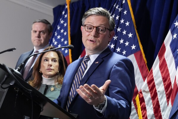 House Speaker Mike Johnson, R-La., center, joined from left by Rep. Jeff Hurd, R-Colo., and Republican Conference Chair Lisa McClain, R-Mich., during a news conference at the Republican National Committee headquarters in Washington, Wednesday, Jan. 22, 2025. (AP Photo/J. Scott Applewhite)