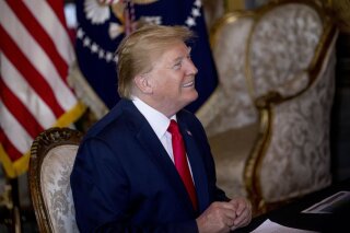 President Donald Trump speaks during a Christmas Eve video teleconference with members of the military at his Mar-a-Lago estate in Palm Beach, Fla., Tuesday, Dec. 24, 2019. (AP Photo/Andrew Harnik)