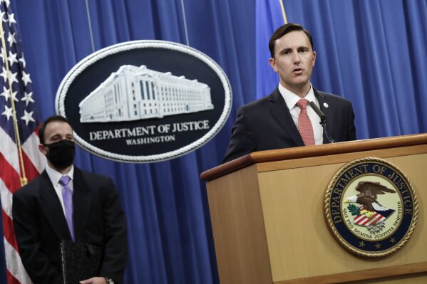 Acting Assistant Attorney General Brian Rabbitt, of the Justice Department's Criminal Division and other officials, speak, Thursday,  Oct. 22, 2020, at the Justice Department in Washington. A subsidiary of Goldman Sachs pleaded guilty on Thursday and agreed to pay more than $2 billion in a foreign corruption probe tied to the Malaysian 1MDB sovereign wealth fund, which was looted of billions of dollars in a corruption scandal.  The company, Goldman Sachs Malaysia, entered the plea in federal court in Brooklyn. (Yuri Gripas/The New York Times via AP, Pool)
