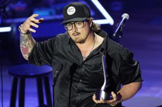 FILE - Hardy accepts the Songwriter of the Year award during the Academy of Country Music Honors awards on Aug. 24, 2022, in Nashville, Tenn. A tour bus carrying country music singer and songwriter Hardy and three others was involved in a crash that injured everyone on board. (AP Photo/Mark Humphrey, File)