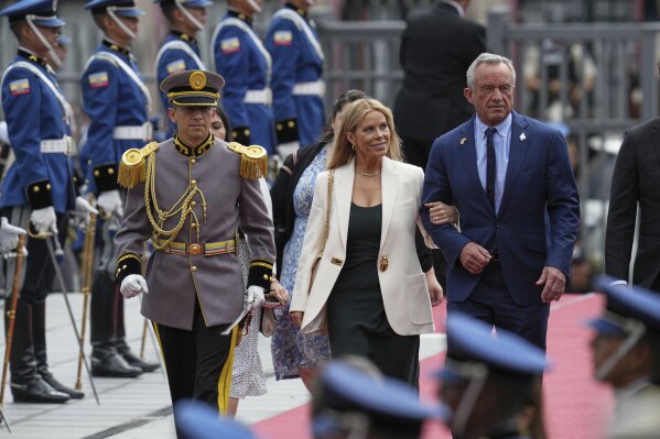 U.S. Secretary of Health and Human Services Robert Kennedy Jr. and his wife Cheryl Hines arrive for the swearing-in ceremony for a second term of Ecuador's President Daniel Noboa at the National Assembly in Quito, Ecuador, Saturday, May 24, 2025. (AP Photo/Dolores Ochoa)
