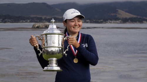 Allisen Corpuz poses with the winner's trophy after the U.S. Women's Open golf tournament at the Pebble Beach Golf Links, Sunday, July 9, 2023, in Pebble Beach, Calif. (AP Photo/Darron Cummings)