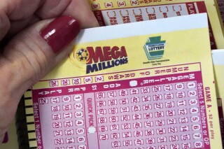 FILE - A Mega Millions wagering slip is held in Cranberry Township, Pa., Jan. 12, 2023. The Mega Millions jackpot has grown again, to at least an estimated $640 million, after there was no winner Friday night, July 14. (AP Photo/Gene J. Puskar, File)