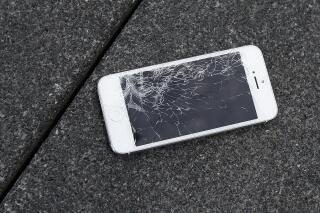 FILE - This Aug. 26, 2015 photo shows an Apple iPhone with a cracked screen after a drop test from the DropBot, a robot used to measure the sustainability of a phone to dropping, at the offices of SquareTrade in San Francisco.   As  software and technology gets infused in more and more products, manufacturers are increasingly making those products difficult to repair, potentially costing business owners time and money. Makers of products ranging from smartphones to farm equipment can withhold repair tools and create software-based locks that prevent even simple updates, unless they’re done by a repair shop authorized by the company.  (AP Photo/Ben Margot, File)